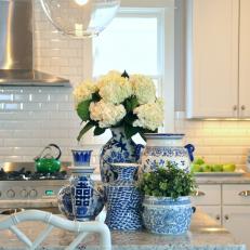 White Kitchen with Flowers on a Decorated Island