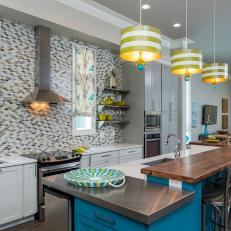 Vibrant Kitchen with Yellow and Gray Tile and Wood and Stainless Steel Island