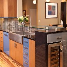 Modern Kitchen with Blue and Wood Cabinets and Black Marble Counters