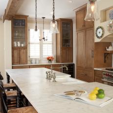 Rustic Kitchen with Built-in Cabinets, Pendant Lights, Wood Beam and Island
