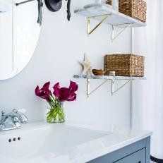 Contemporary White and Blue Bathroom with White Marble Shelves and Baskets