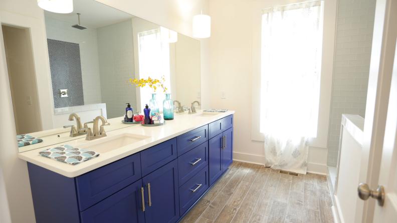Neutral Bathroom With Blue Double Vanity and Wood-Look Tile Floor