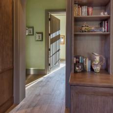 Arch Doorway Over Hardwood Hall With Built In Wood Bookshelf for Decorative Storage 