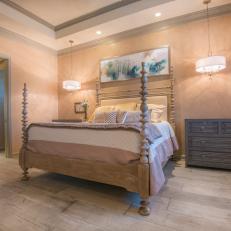 Classy Transitional Bedroom With Decorative Carved Bed Posts, Textured Dresser and Peach Walls 
