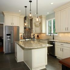 Transitional Kitchen With Glass Pendant Lights and Neutral Wood Cabinets