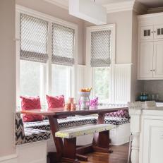 Chic Breakfast Nook With Built-In Banquette and Patterned Shades