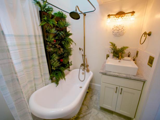 Reveal of Ben and Callie's bathroom, featuring a claw foot tub and live-in wall with real plants.