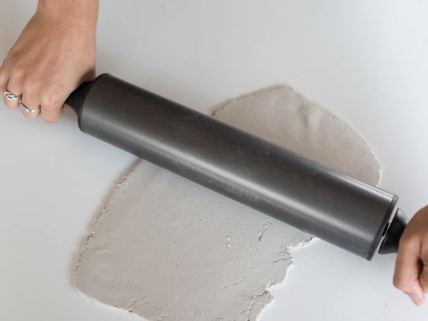Place half of clay slab on clean, non-stick work surface. Roll out with rolling pin to ¼ thickness in a loose rectangular shape.