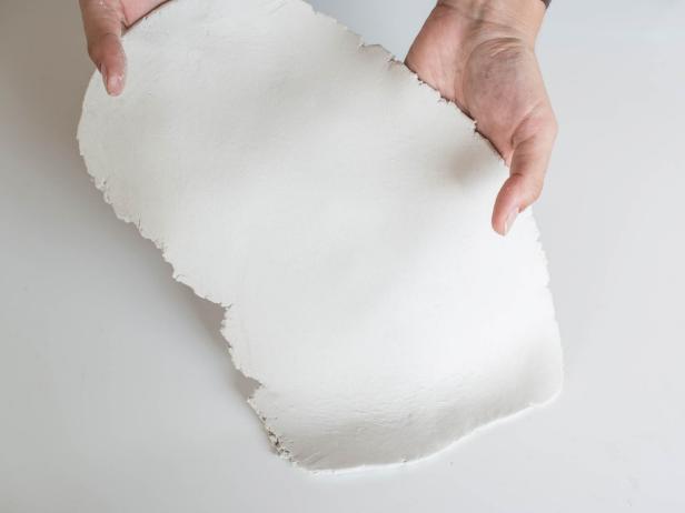 Place half of clay slab on clean, non-stick work surface. Roll out with rolling pin to ¼ thickness in a loose rectangular shape.