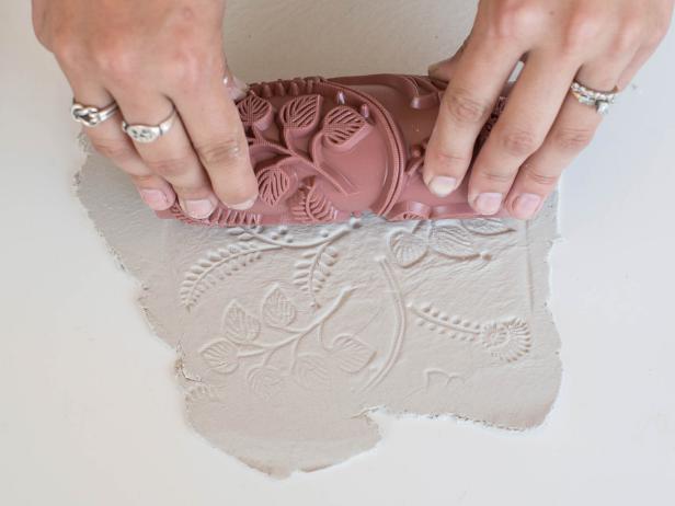 Use stamps or plastic knife to create a pattern in rolled-out clay. Tip: Clay can also be imprinted with fabric, lace, flowers, leaves, shells, etc. Test it out and, if it doesn't look good, just roll out the clay and try again. The options really are endless!