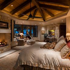 Cozy Master Bedroom With Fireplace and Exposed Beam Ceiling