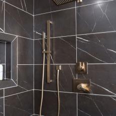 Modern Shower with Black Marble Tiles and Gold Fixtures