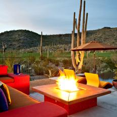 Cozy Outdoor Sitting Area With Fire Pit and Colorful Sectional