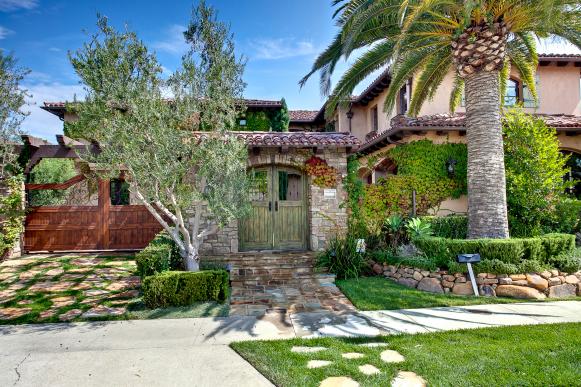 Mediterranean Exterior With Palm Tree and Stone Walkway