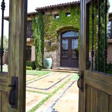 Wooden Gate Peeks Into Mediterranean Home's Entry