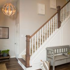 Rustic Neutral Foyer with White Railing and Paneling