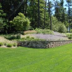 Ornamental Grass Landscaping With Natural Stone Retaining Wall 