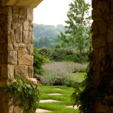 Rustic Stone Archway Leads to Formal Garden