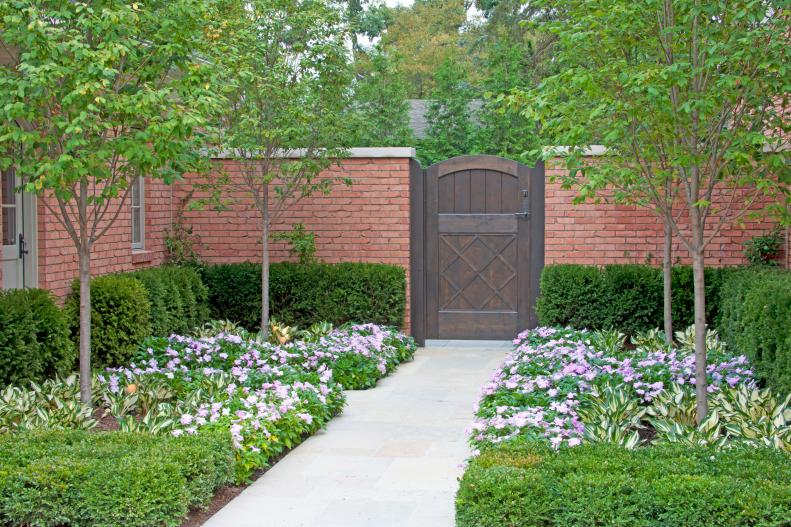 Traditional Outdoor Space With Brick Wall, Stone Walkway