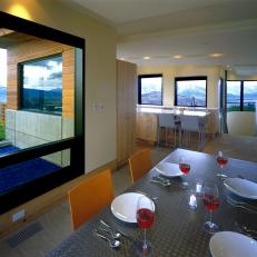 Modern Dining Room Featuring Stainless Steel Dining Table and Gorgeous Mountain Views 