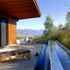 Decorative Water Trough Home Border With Concrete Shaded Patio and Mountain View 