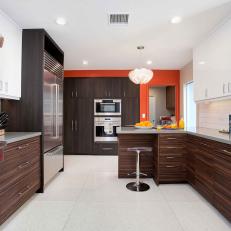 Deep Orange Accent Wall in Bright Midcentury Modern Kitchen With Woodgrain Cabinetry 