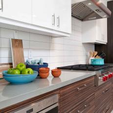 Gray Countertop Separates White and Woodgrain Cabinets in Midcentury Modern Kitchen 