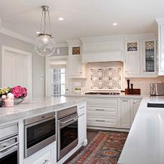 Timeless Style Transitional Kitchen Featuring Large Island, White Cabinets and a Mix of White and Gray Marble Countertop