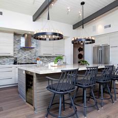 Circular Pendant Chandeliers, Black Bar Chairs and Midcentury Modern Cabinetry in Sleek Kitchen Design