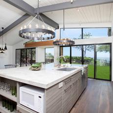 Large, Midcentury Modern Kitchen Island With Ashy Woodgrain, White Marble Countertop and Industrial, Circle Chandeliers