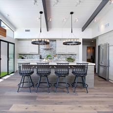 Sunny Midcentury Modern Kitchen Featuring Ashy Neutral Tones, Industrial Inspired Light Fixtures and White Cabinets