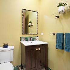 Yellow Mediterranean Powder Room With Blue Towels
