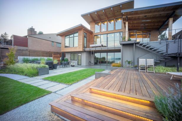 Back of Contemporary Exterior With Wood Decking, Gravel, Green Grass