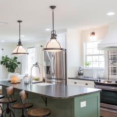 Contemporary White Kitchen with Green Island and Black Countertops