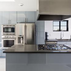 Modern Kitchen With Custom Gray Cabinets and Fume Hood
