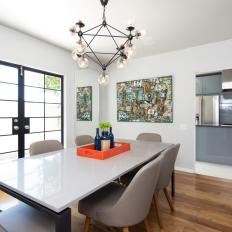 Modern Dining Room With Gray Chairs and Geometric Chandelier