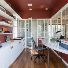 Modern Home Office with Burgundy Walls and Custom Cabinets