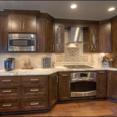 Contemporary Kitchen With Granite Countertop and Tile Backsplash