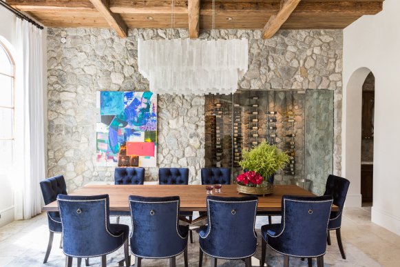 Dining Room With Blue Chairs, Stone Wall and Wood Ceiling
