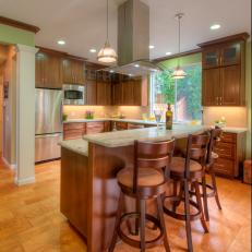 Green Open Plan Kitchen With Curved Barstools