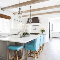 White Open Kitchen With Blue Barstools