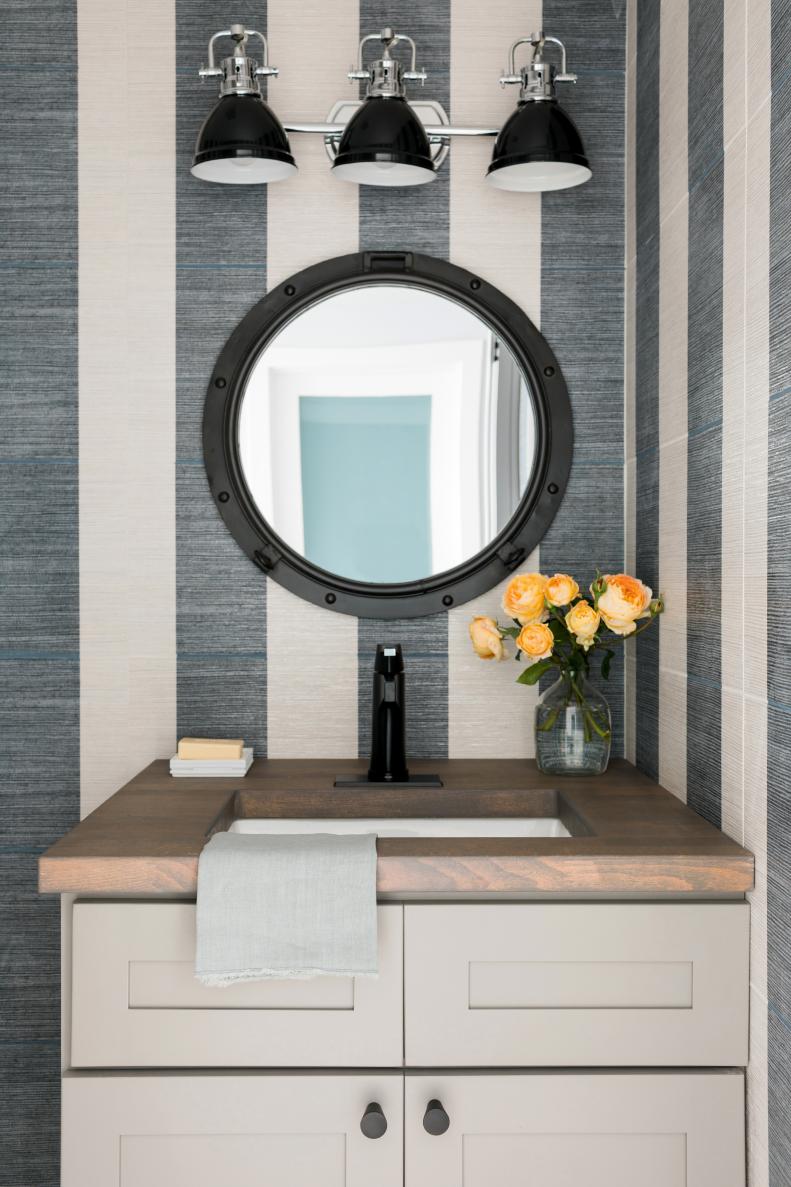 The powder room’s Shaker vanity has a custom wood countertop that adds warmth to the space.