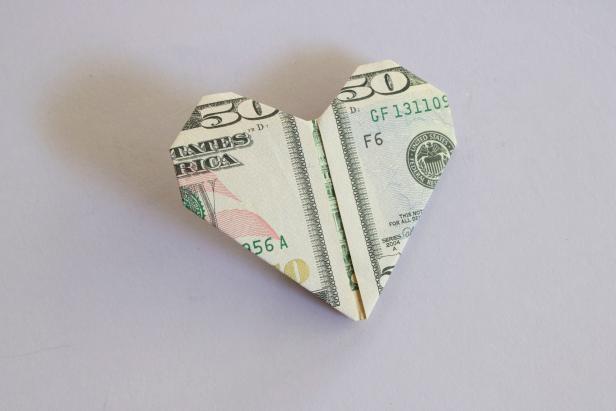 Step-by-step instructions on how to fold a dollar bill into an origami heart.