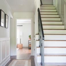 Contemporary White Foyer with Brown Hardwood Floors 