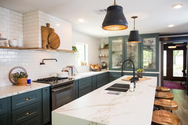The kitchen of the newly renovated Jones home has been completely transformed. A wall was removed to increase the size of the kitchen and to add to the open feel of the home. Some key elements are the stainless steel appliances, farm sink, pantry, and subway inspired tile on the backsplash, as seen on Fixer Upper. (after)