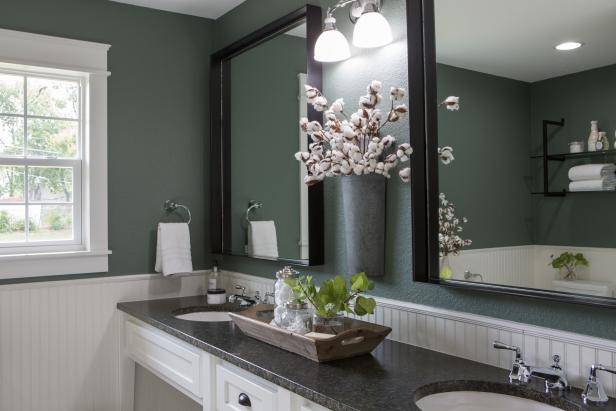 As seen on Fixer Upper, the Grahams' renovated main bathroom has new countertops, light fixtures, mirrors and dual sinks. (After)
