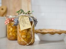 Preserve fall flavors and impress your friends and family with this canned apple pie filling presented as holiday gifts. The recipe gets an extra kick from spiced rum.
