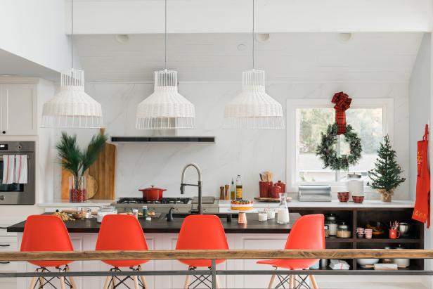 You’ll need your kitchen in good working order to serve up all those hors d’oeuvres, brunches, and hot-cocoa sessions, but you can still work in some cheery touches without crowding your counters with ornaments. An oversized ribbon-rosette gives a basic wreath a richer look; swap out your crocks and casseroles for some rosy red ones, and tuck some fresh greens into the corners.