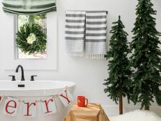 A miniature wreath and some merry accents will make even the most utilitarian space feel like part of the festivities. Just be sure not to choose anything that could be damaged by water or humidity, toothpaste, or makeup.
