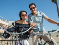 Host Drew Scott and fiancee Linda Phan get ready for a bike ride on the Venice Beach boardwalk, as seen on Property Brothers at Home: Drew’s Honeymoon House.